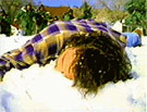 Adam collapses in the snow.